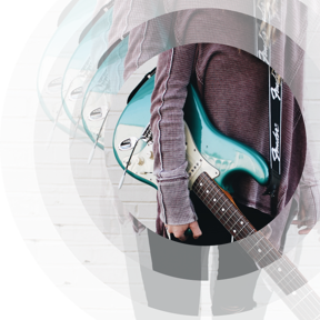 Someone holding a guitar under their arm